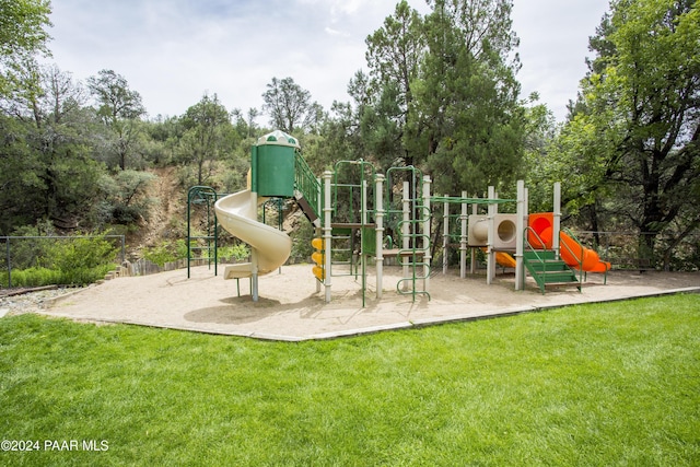 view of playground with a lawn