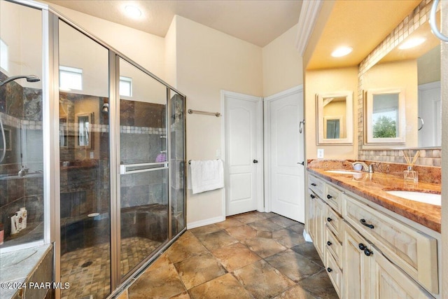 bathroom featuring vanity and a shower with door