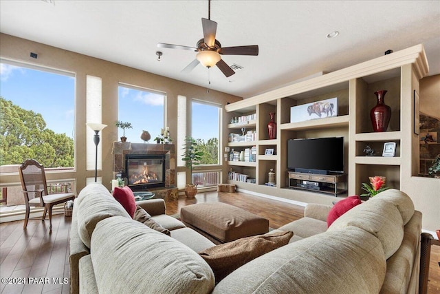 living room with ceiling fan and wood-type flooring