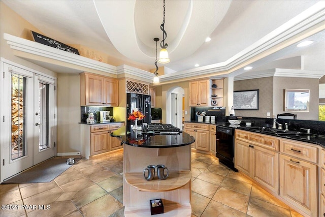 kitchen with french doors, a raised ceiling, black appliances, pendant lighting, and a center island