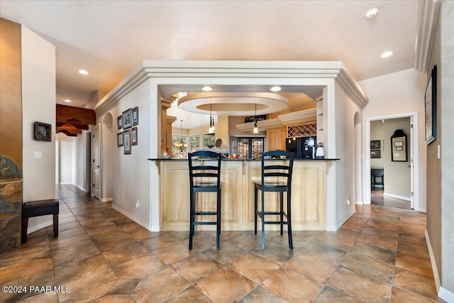 kitchen with a breakfast bar area, kitchen peninsula, and black fridge