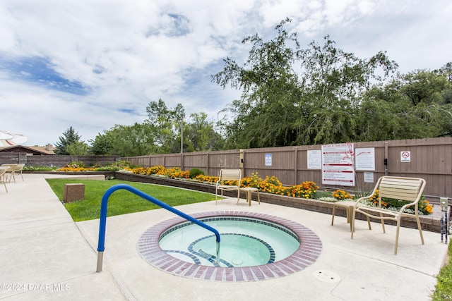 view of pool with a hot tub