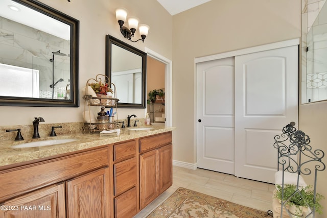 bathroom featuring vanity and tiled shower