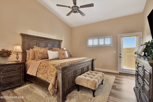 bedroom featuring access to exterior, ceiling fan, light hardwood / wood-style flooring, and high vaulted ceiling