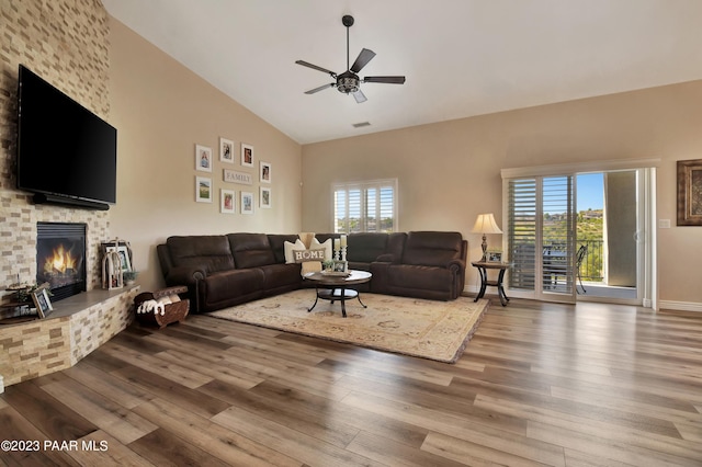 living room with ceiling fan, a fireplace, high vaulted ceiling, and hardwood / wood-style flooring