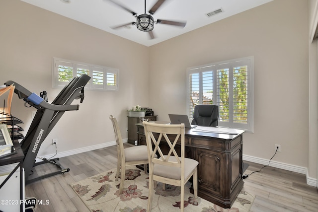 office area featuring ceiling fan, a wealth of natural light, and light hardwood / wood-style flooring