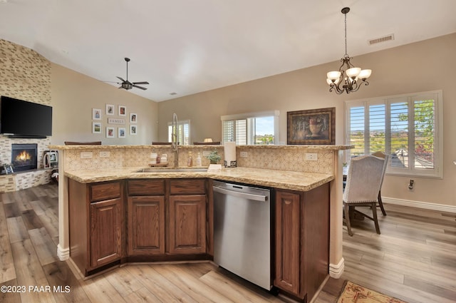 kitchen with dishwasher, a healthy amount of sunlight, lofted ceiling, and light hardwood / wood-style flooring