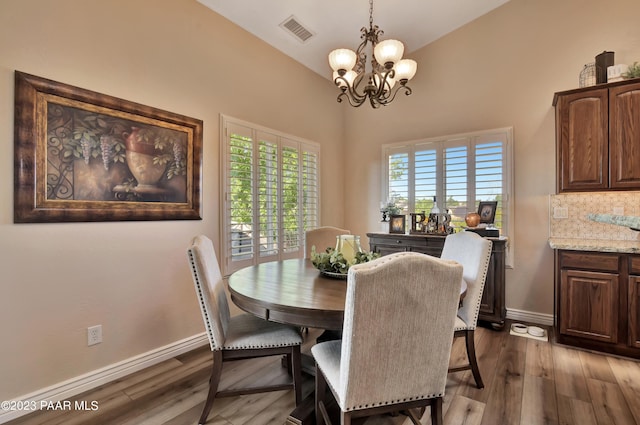 dining room with a chandelier and dark wood-type flooring