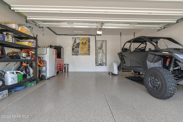 garage featuring white fridge, a garage door opener, and water heater