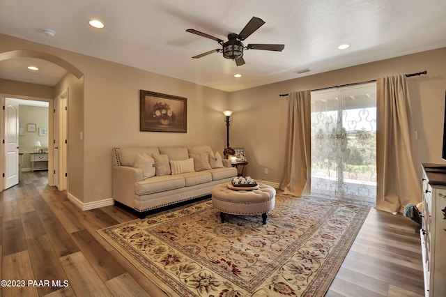 living room featuring ceiling fan and hardwood / wood-style flooring