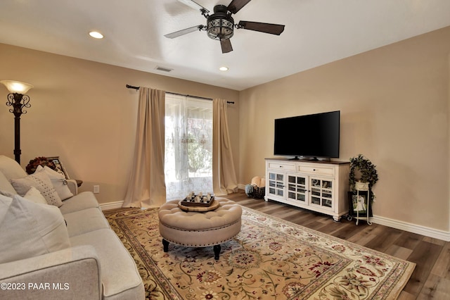 living room with dark hardwood / wood-style floors and ceiling fan