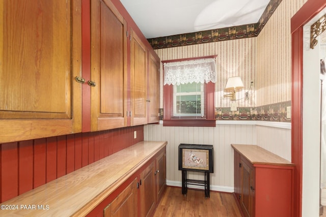 bar with wood counters and light wood-type flooring