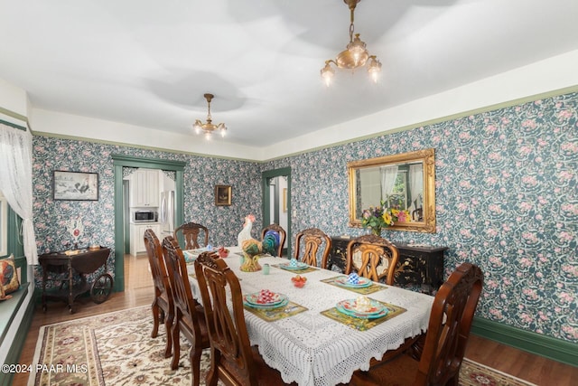 dining space with hardwood / wood-style floors