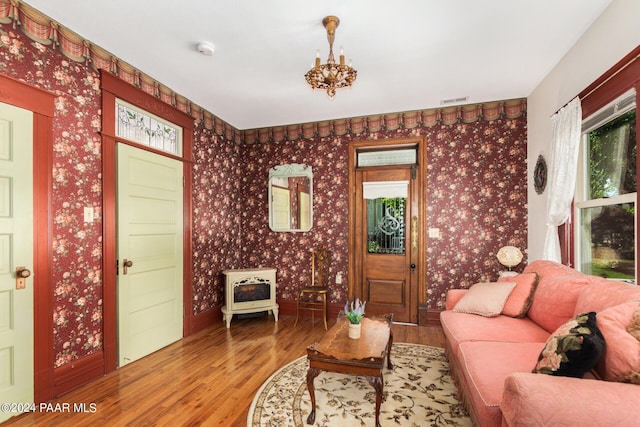 living room with hardwood / wood-style flooring and a notable chandelier