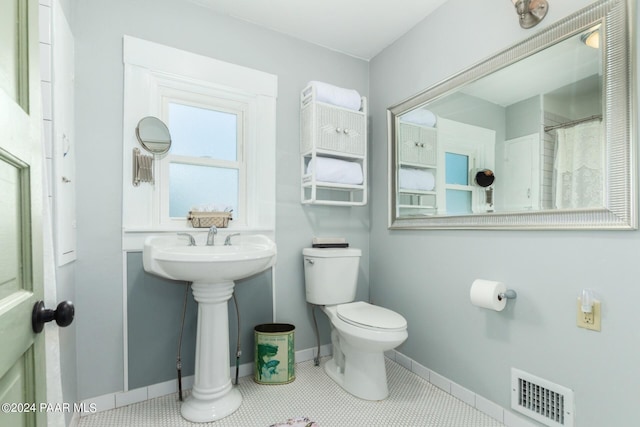 bathroom featuring tile patterned floors and toilet