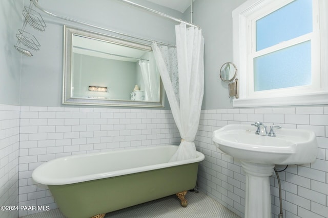 bathroom with tile patterned floors and tile walls