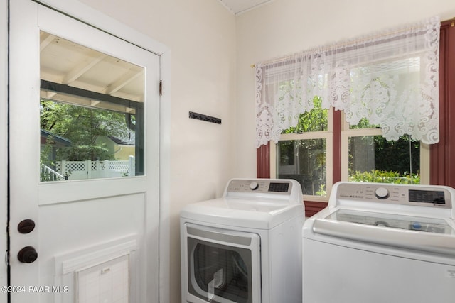 laundry area with independent washer and dryer and a wealth of natural light