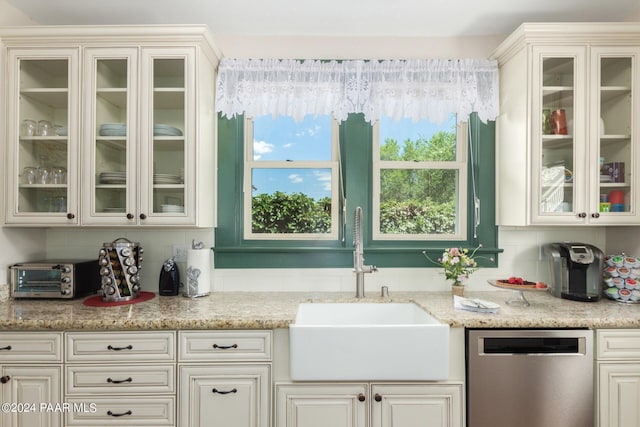 kitchen featuring dishwasher, tasteful backsplash, light stone counters, and a wealth of natural light