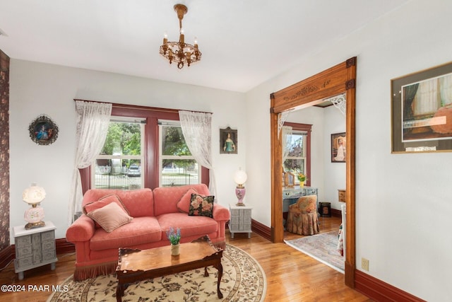 living room featuring light hardwood / wood-style floors and an inviting chandelier