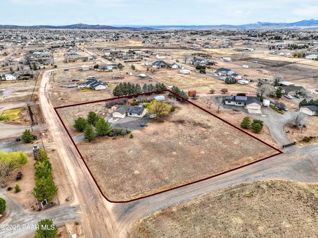 birds eye view of property featuring view of desert and a mountain view