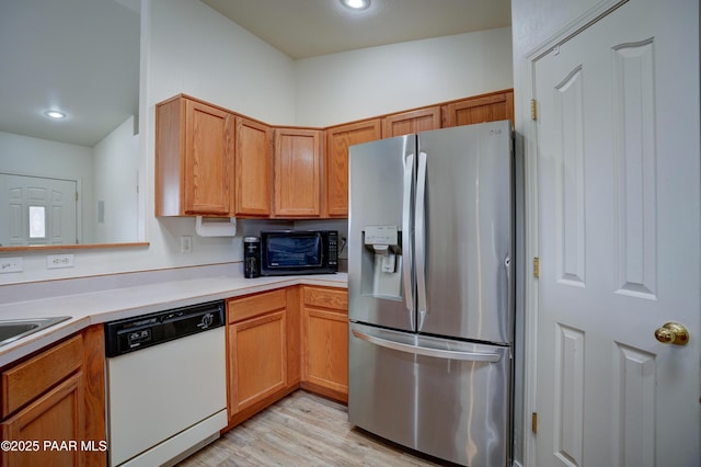 kitchen with light countertops, black microwave, stainless steel fridge with ice dispenser, white dishwasher, and light wood-style floors