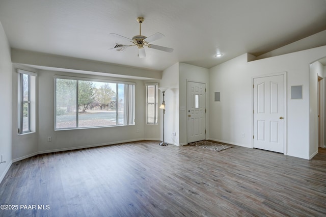 interior space with baseboards, lofted ceiling, wood finished floors, and a ceiling fan