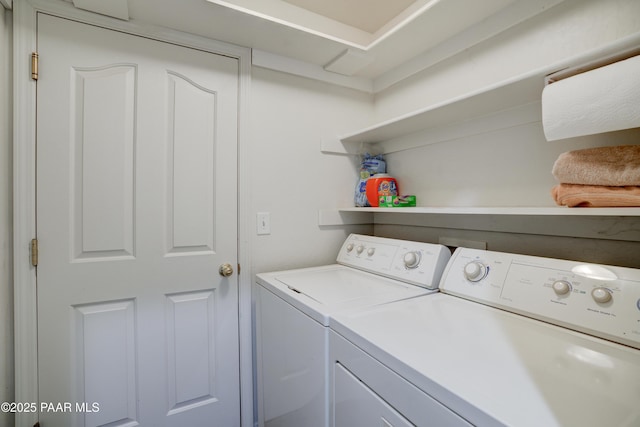 clothes washing area with separate washer and dryer and laundry area