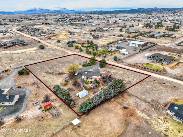 drone / aerial view featuring a rural view, a mountain view, and a desert view