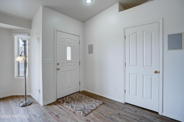 entryway with baseboards and wood finished floors