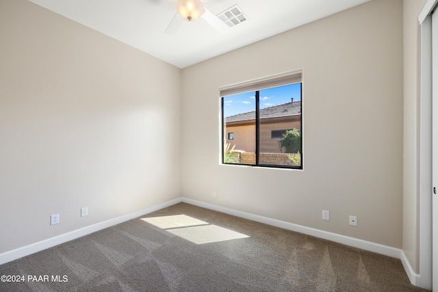 empty room featuring ceiling fan and carpet floors