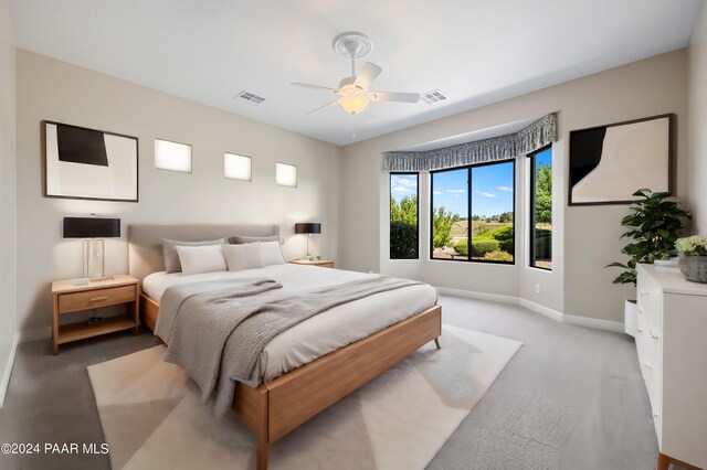 bedroom featuring ceiling fan and light colored carpet