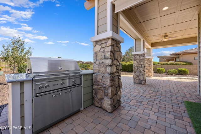 view of patio with ceiling fan and area for grilling