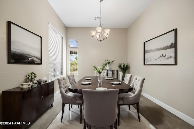 carpeted dining area featuring a notable chandelier