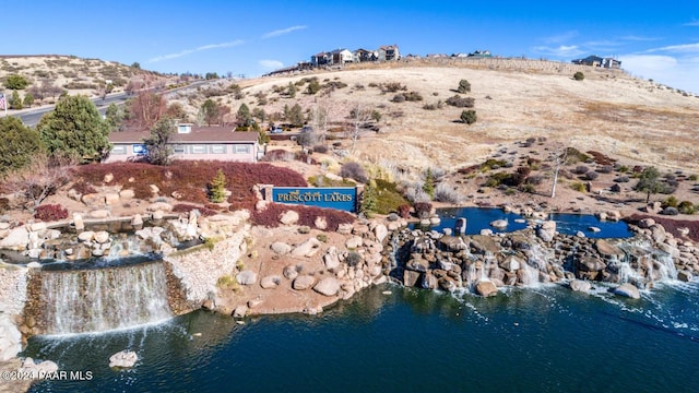 aerial view featuring a water and mountain view