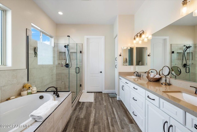 bathroom featuring separate shower and tub, hardwood / wood-style floors, and vanity