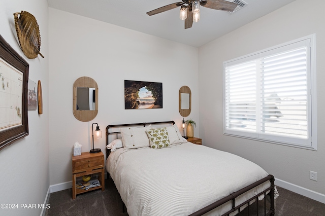 bedroom with ceiling fan and dark carpet