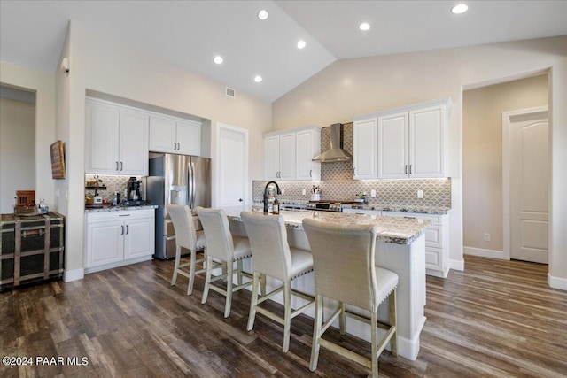 kitchen featuring white cabinetry, wall chimney range hood, and dark wood-type flooring