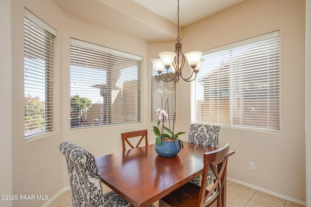 dining space featuring an inviting chandelier, baseboards, and light tile patterned flooring