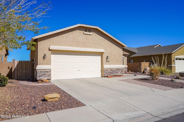 single story home featuring a garage, stucco siding, stone siding, and concrete driveway