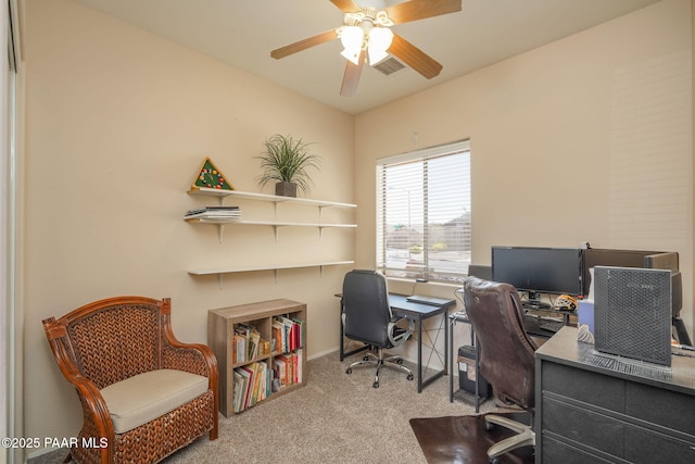 home office featuring carpet floors, ceiling fan, and visible vents