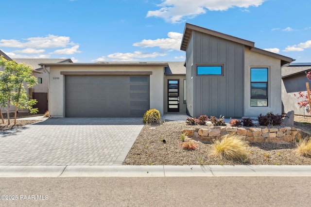 5248 Tranquil Bluff Way, Prescott, AZ 86301 - view of front of home with board and batten siding, an attached garage, and decorative driveway