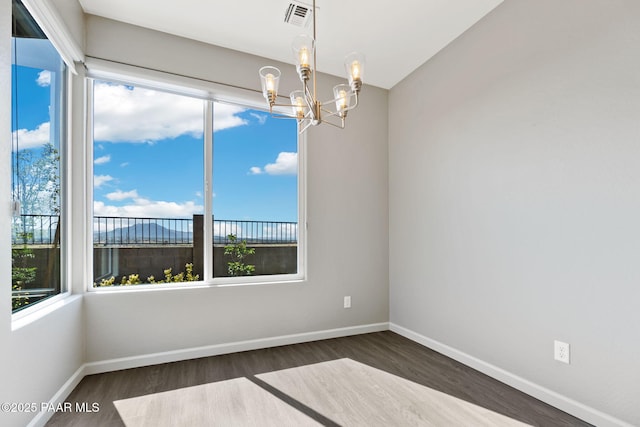 5248 Tranquil Bluff Way, Prescott, AZ 86301 - unfurnished room with a chandelier, wood finished floors, healthy amount of natural light, and baseboards