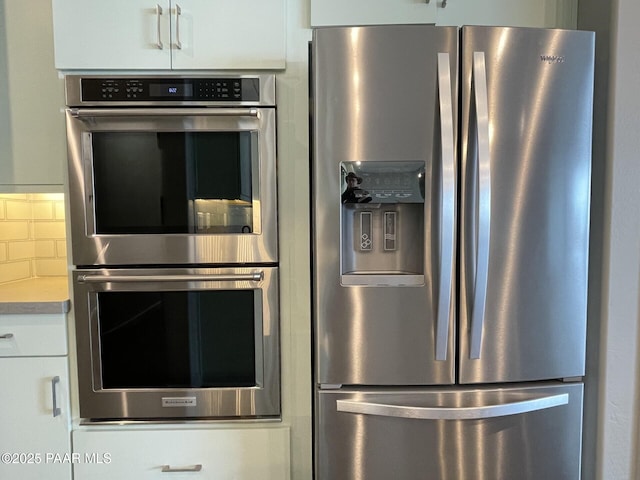 5248 Tranquil Bluff Way, Prescott, AZ 86301 - kitchen with appliances with stainless steel finishes, white cabinetry, light countertops, and decorative backsplash