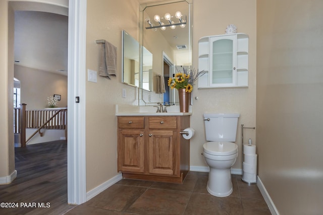 bathroom with plenty of natural light, vanity, a chandelier, and toilet