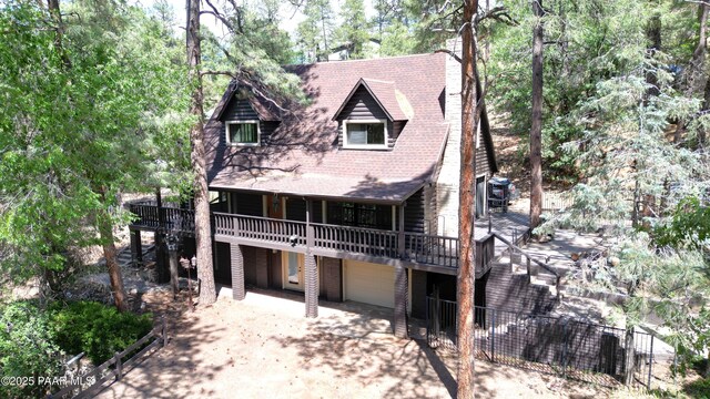 885 S Rancho Vista Dr, Prescott, AZ 86303 - view of front of home featuring driveway, a garage, a wooden deck, and roof with shingles