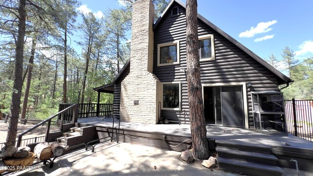 885 S Rancho Vista Dr, Prescott, AZ 86303 - back of house featuring a chimney, a deck, and log veneer siding