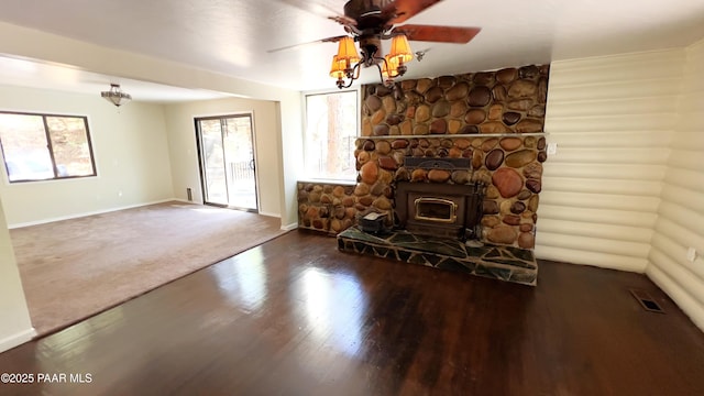 885 S Rancho Vista Dr, Prescott, AZ 86303 - unfurnished living room with wood finished floors, baseboards, a ceiling fan, and a wood stove