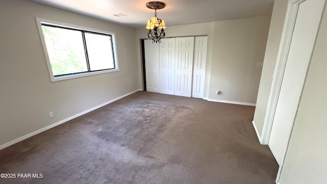 885 S Rancho Vista Dr, Prescott, AZ 86303 - unfurnished bedroom featuring a chandelier, baseboards, carpet, and a closet