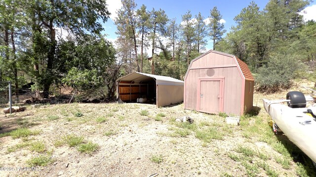 885 S Rancho Vista Dr, Prescott, AZ 86303 - view of shed featuring a detached carport and view of wooded area