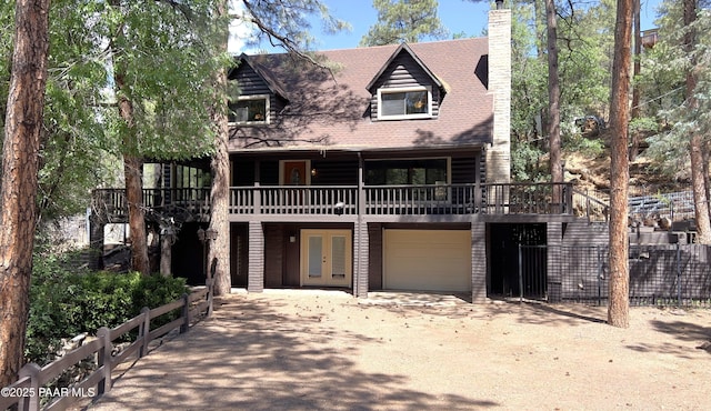 885 S Rancho Vista Dr, Prescott, AZ 86303 - view of front of house featuring french doors, a chimney, driveway, a deck, and a garage